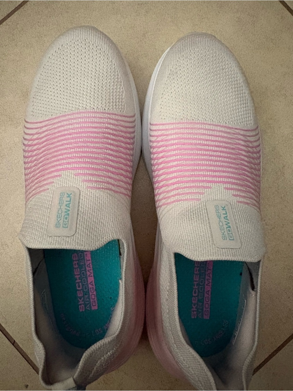 Skechers slip-on knit sneakers in pink and white